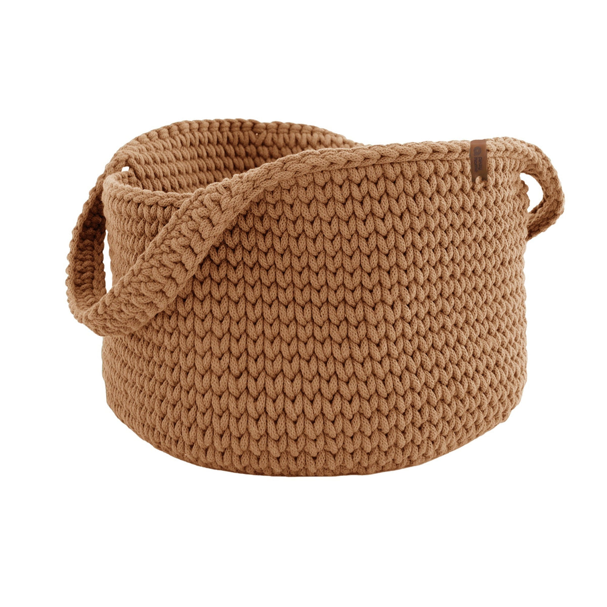 Tan round knit basket with side handles, textured fabric and rolled edge.