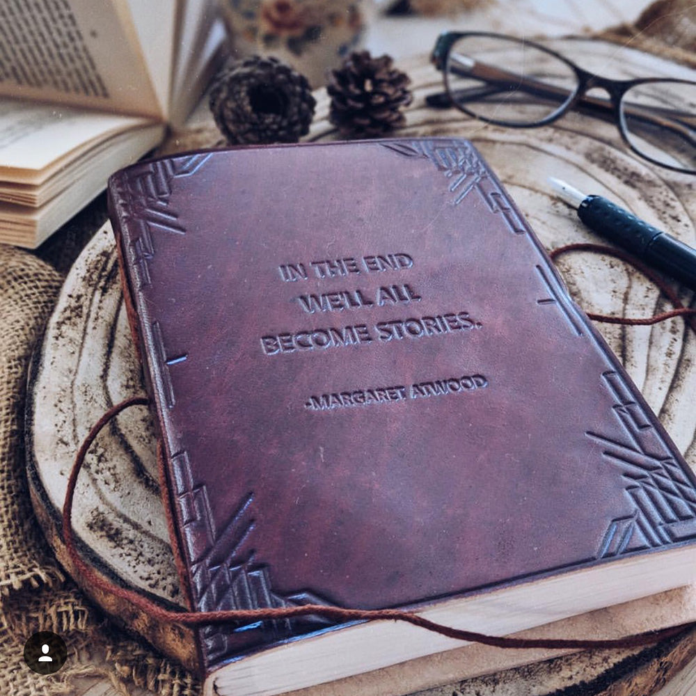 Deep brown leather journal with embossed frame pattern and Margaret Atwood quote, cord tie