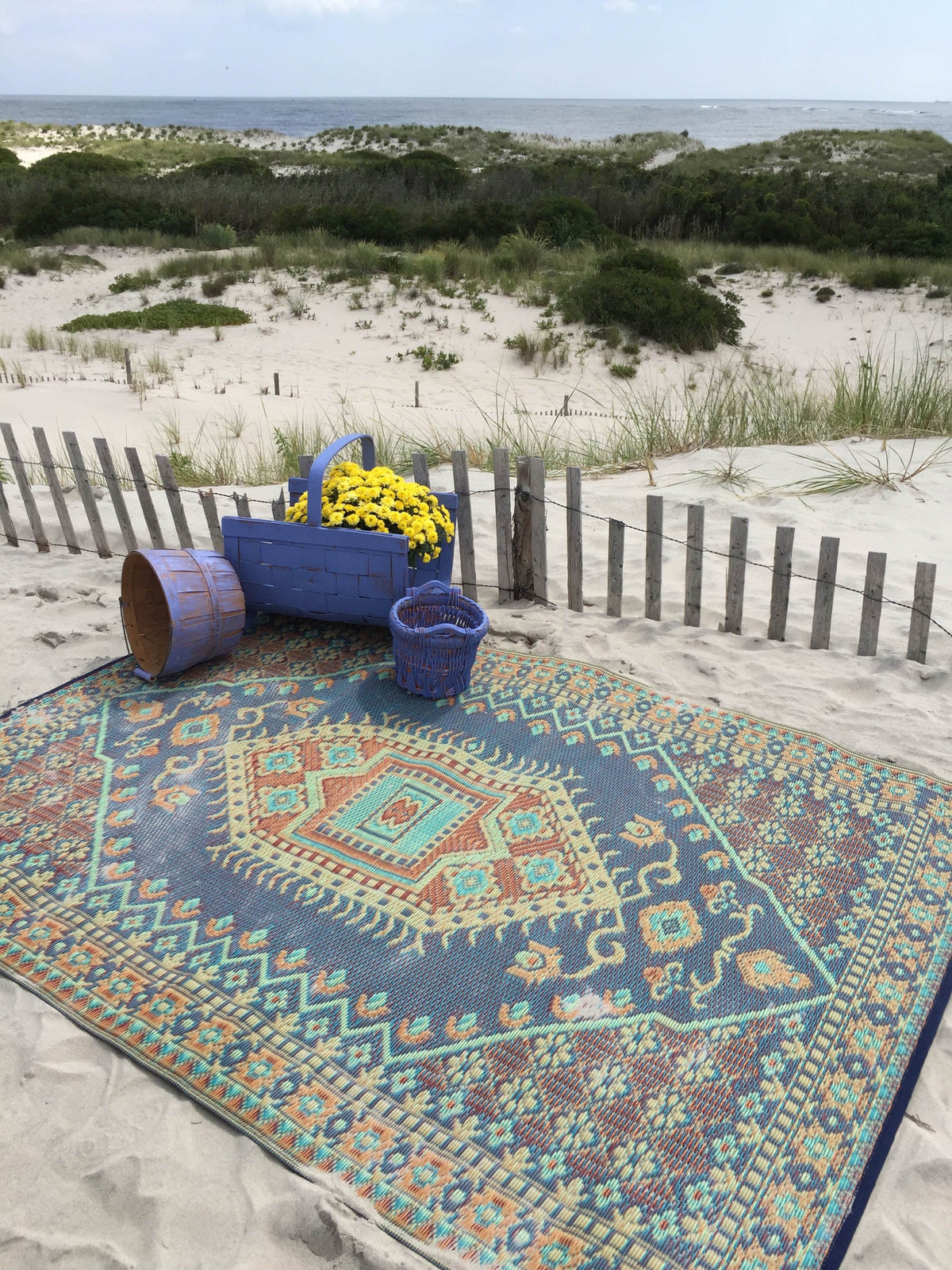 Turkish-style area rug with ornate blue and orange geometric medallion