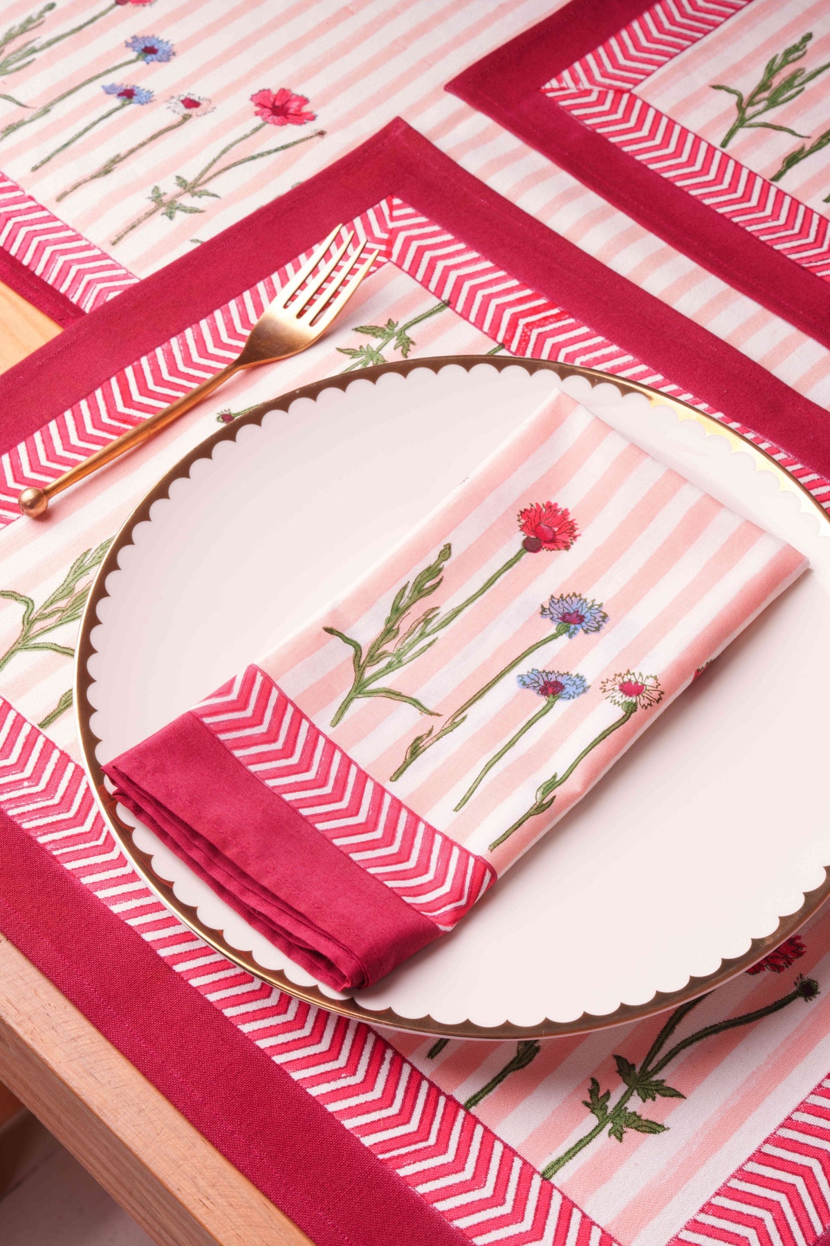 Set of 2 floral placemats with pink striped center and red zigzag border
