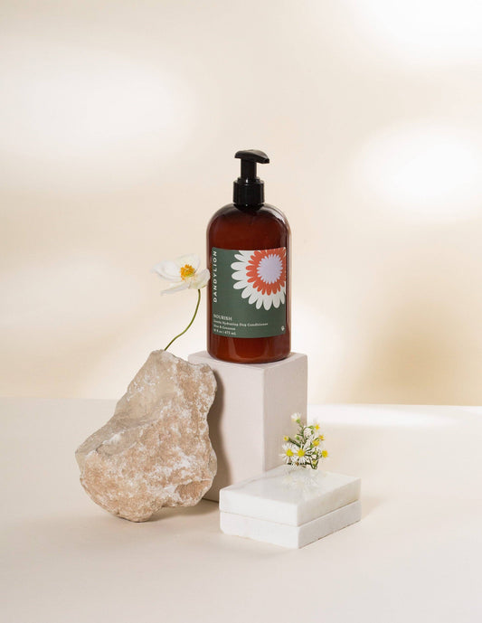 Gentle hydrating dog conditioner bottle with black pump, amber liquid, floral label