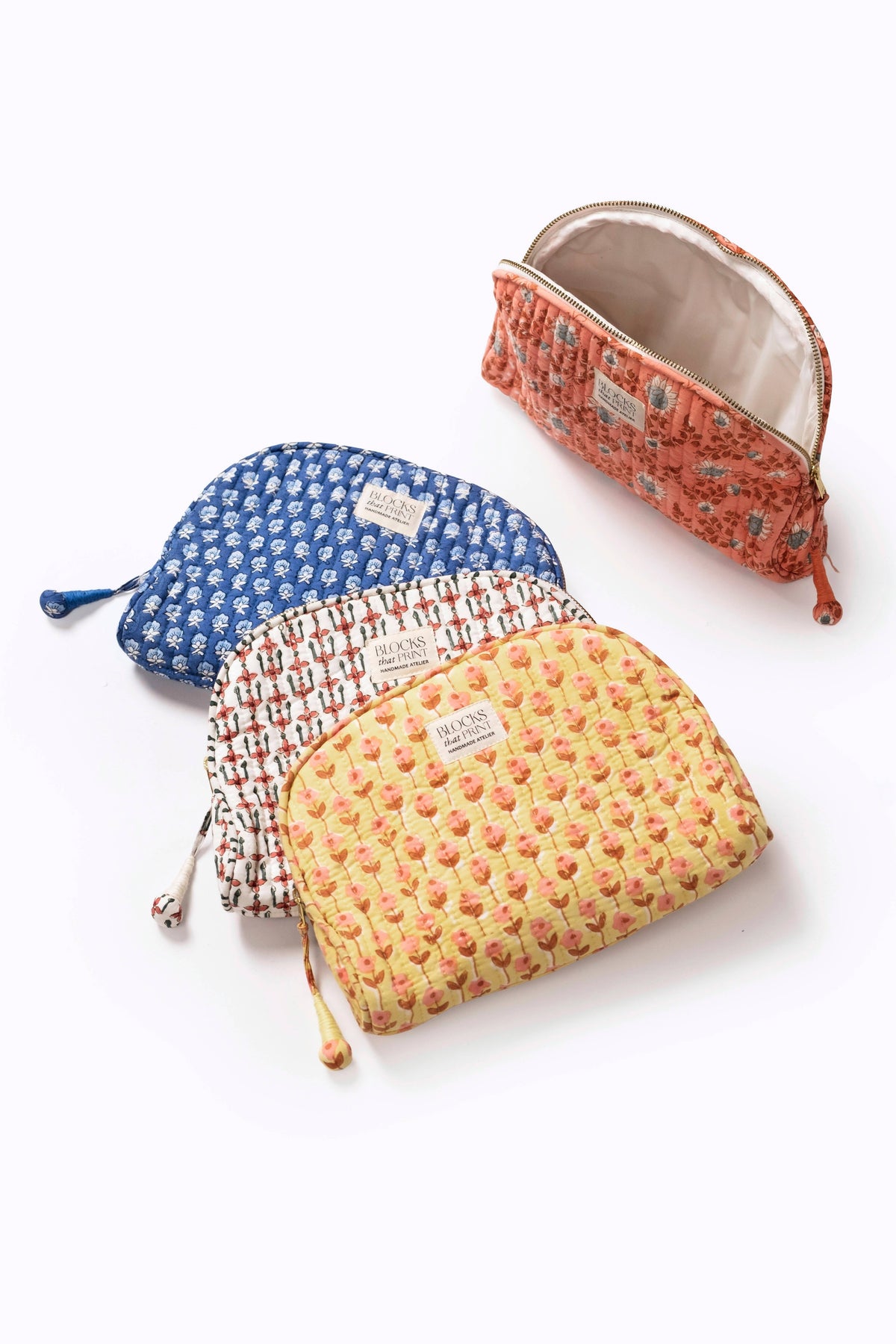 Quilted travel pouches (3) with blue, white/red, and yellow block-print patterns.