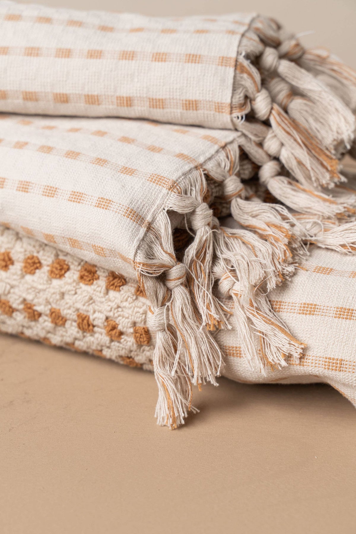 Turkish hand towel detail: stone weave with terracotta pattern and long tasseled fringe