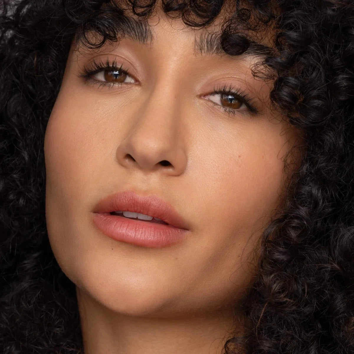 Red-brown lip tint on lips with glossy finish, close-up