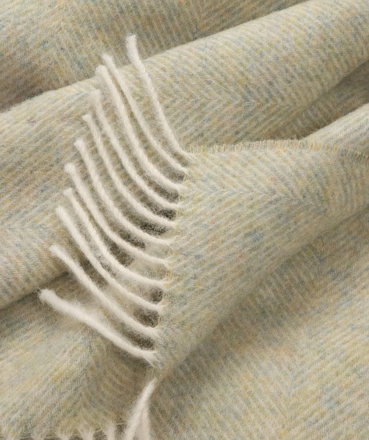 Shetland lambswool herringbone throw close-up with off-white fringe trim