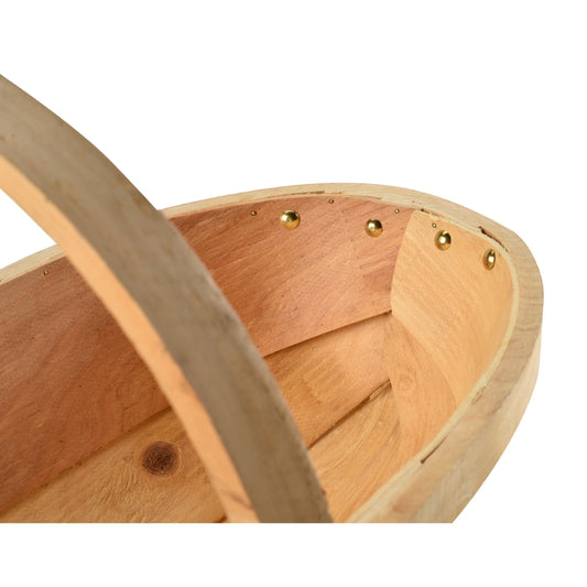 Natural wooden trug interior with arched handle and brass stud details on the rim
