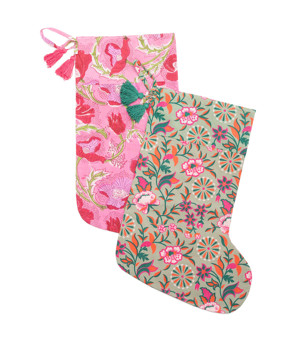 Pink floral block-print cotton holiday stocking with top tassel and hanging loop.