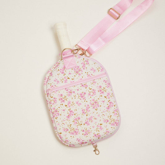 Floral neoprene pickleball paddle bag with pink strap, gold-tone clips, and zip pocket