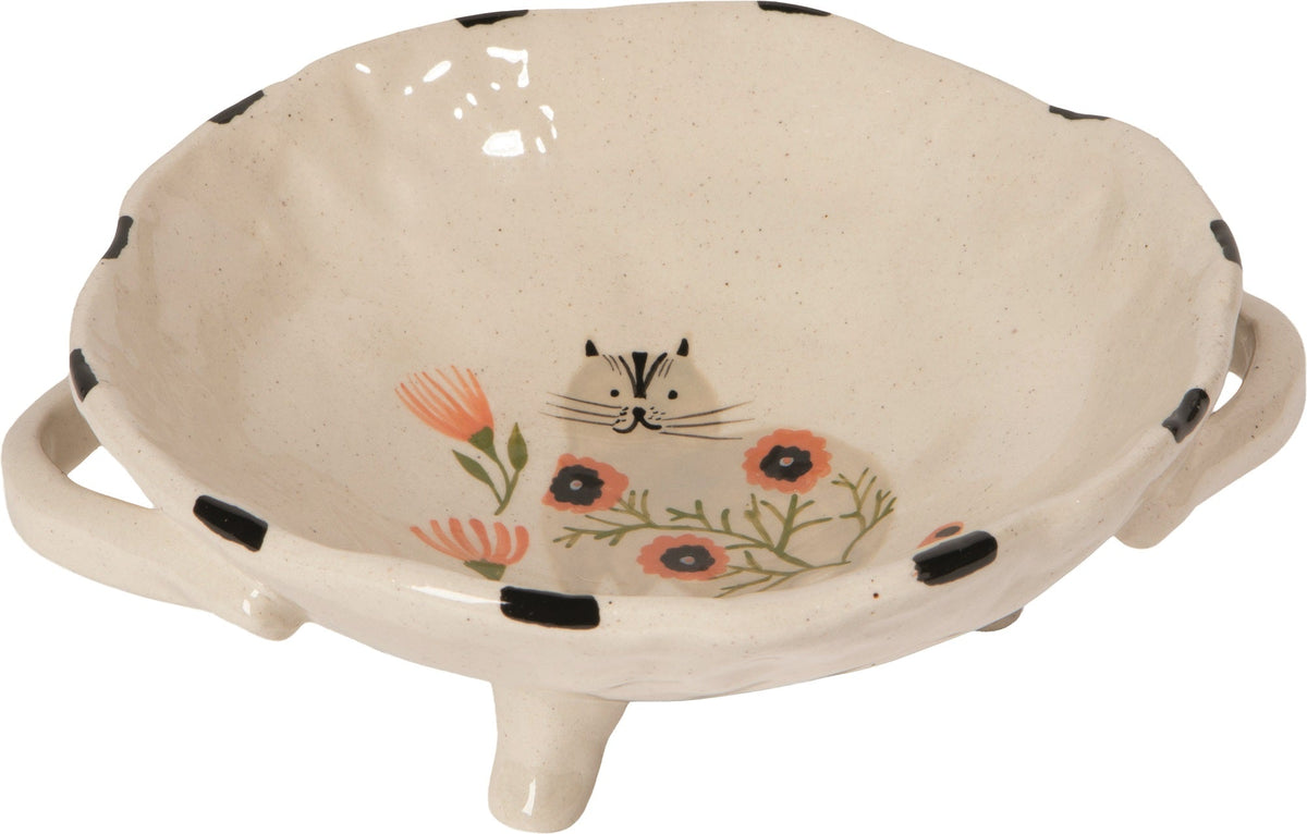 Cream footed bowl with floral cat illustration, black dot rim and side handles