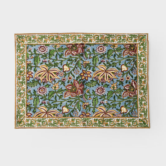 Cotton placemat with green and blue floral pattern and decorative border