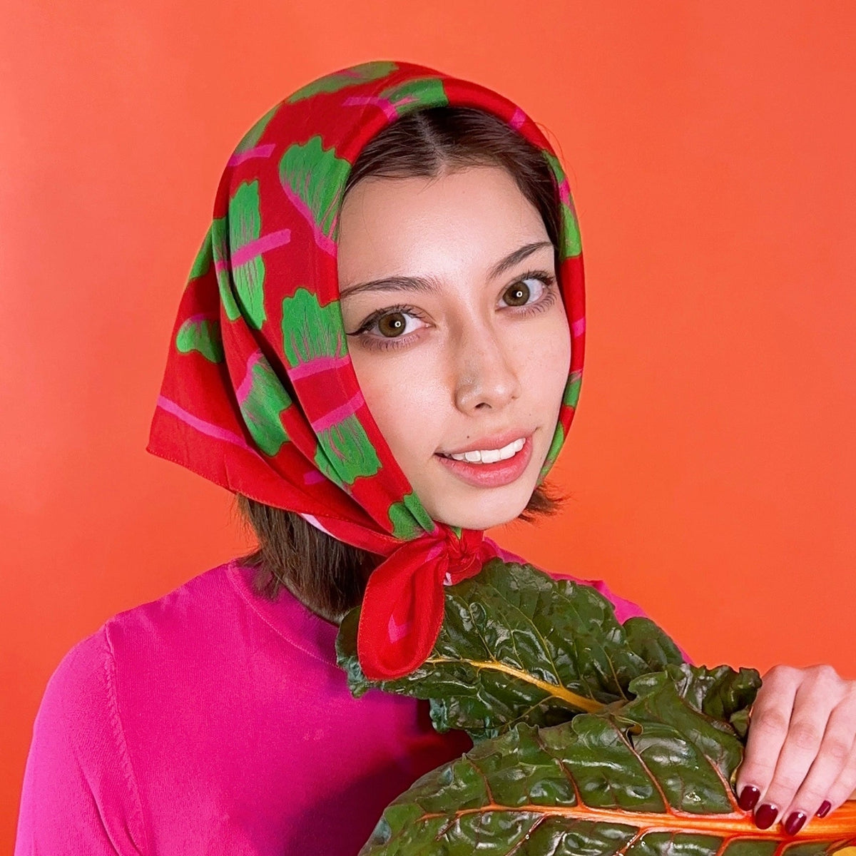 Red headscarf bandana with green leaf print and small front tie