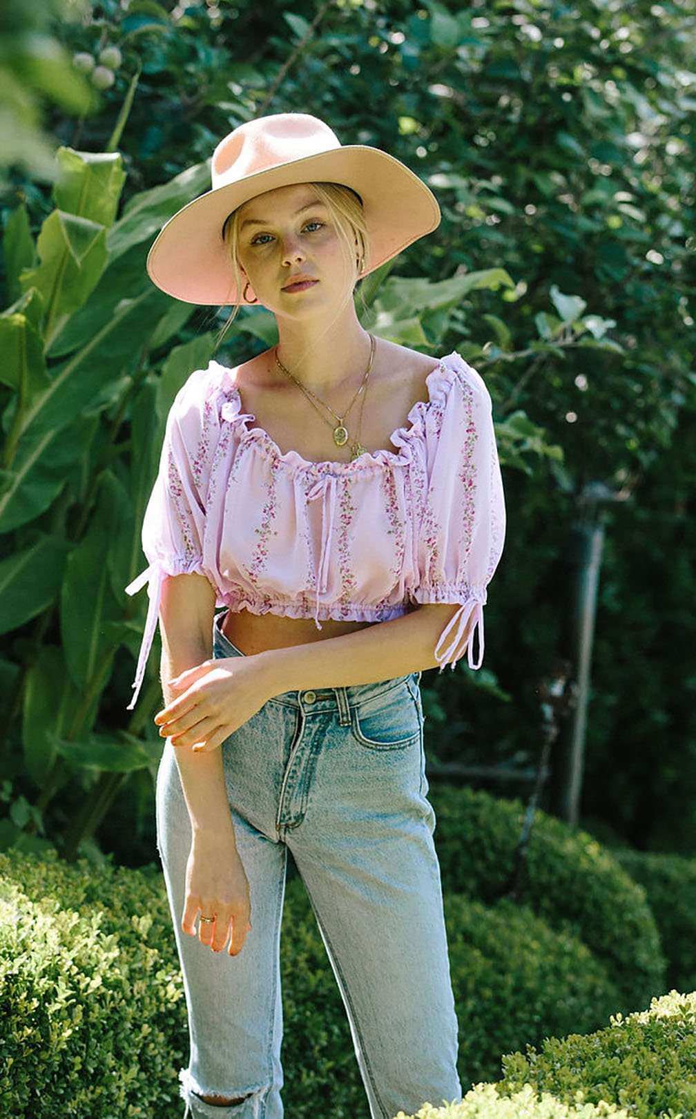Light purple floral cropped blouse with puff sleeves and elasticated hem, front view