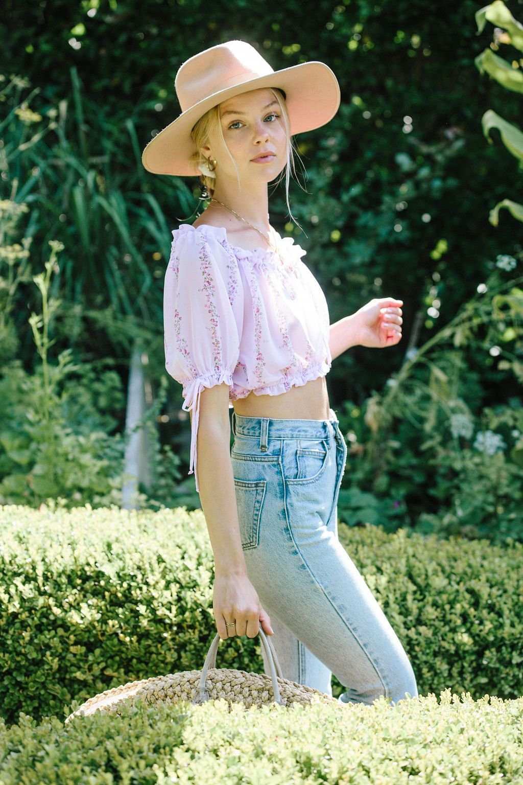 Light purple floral cropped blouse with puff sleeves and drawstring ties at hem