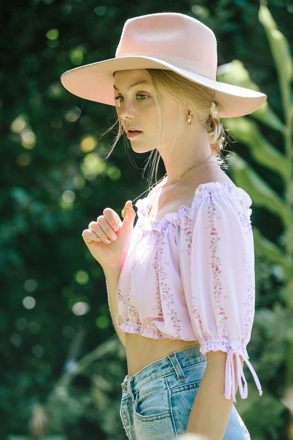 Light purple floral cropped blouse with puff sleeves and ruched neckline, side profile