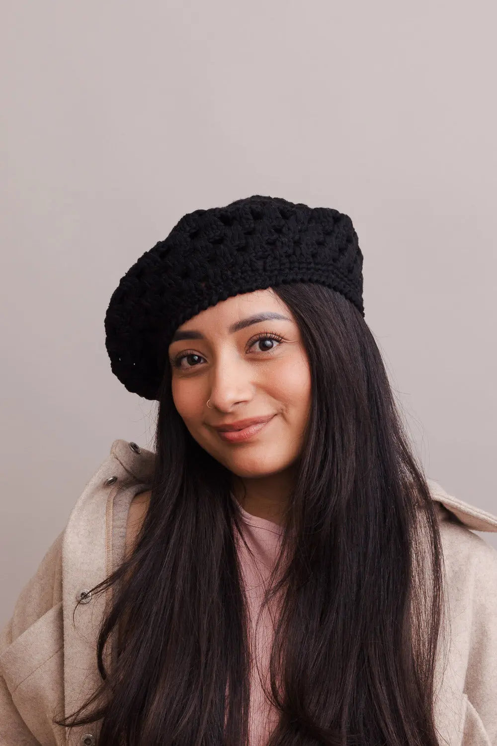 Black crochet knit beret with textured diamond stitch, worn front-facing