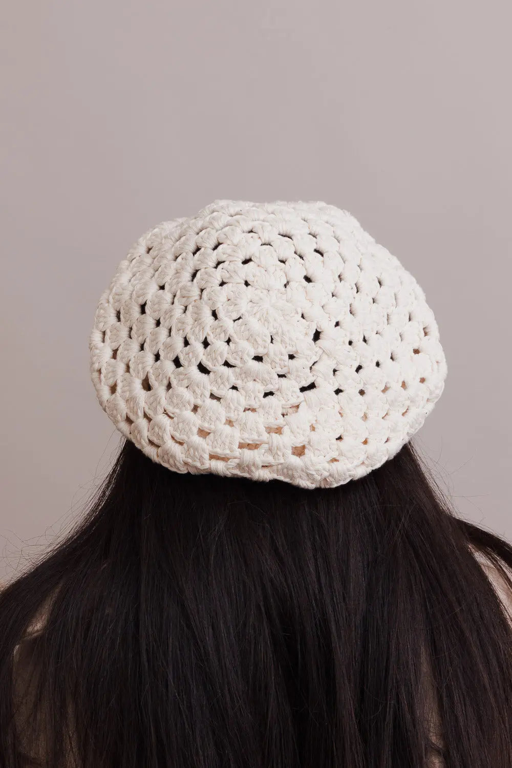 Ivory crochet knit beret with textured diamond pattern, back view