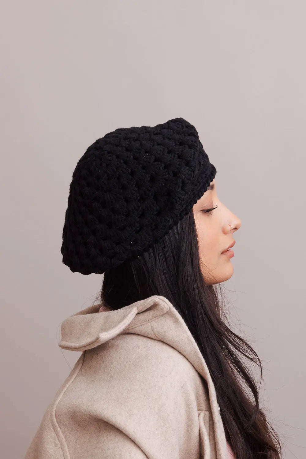 Black crochet knit beret with diamond stitch, worn from the side