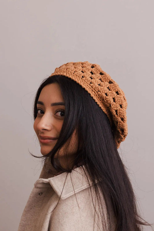 Camel crochet knit beret with diamond stitch, worn angled on model