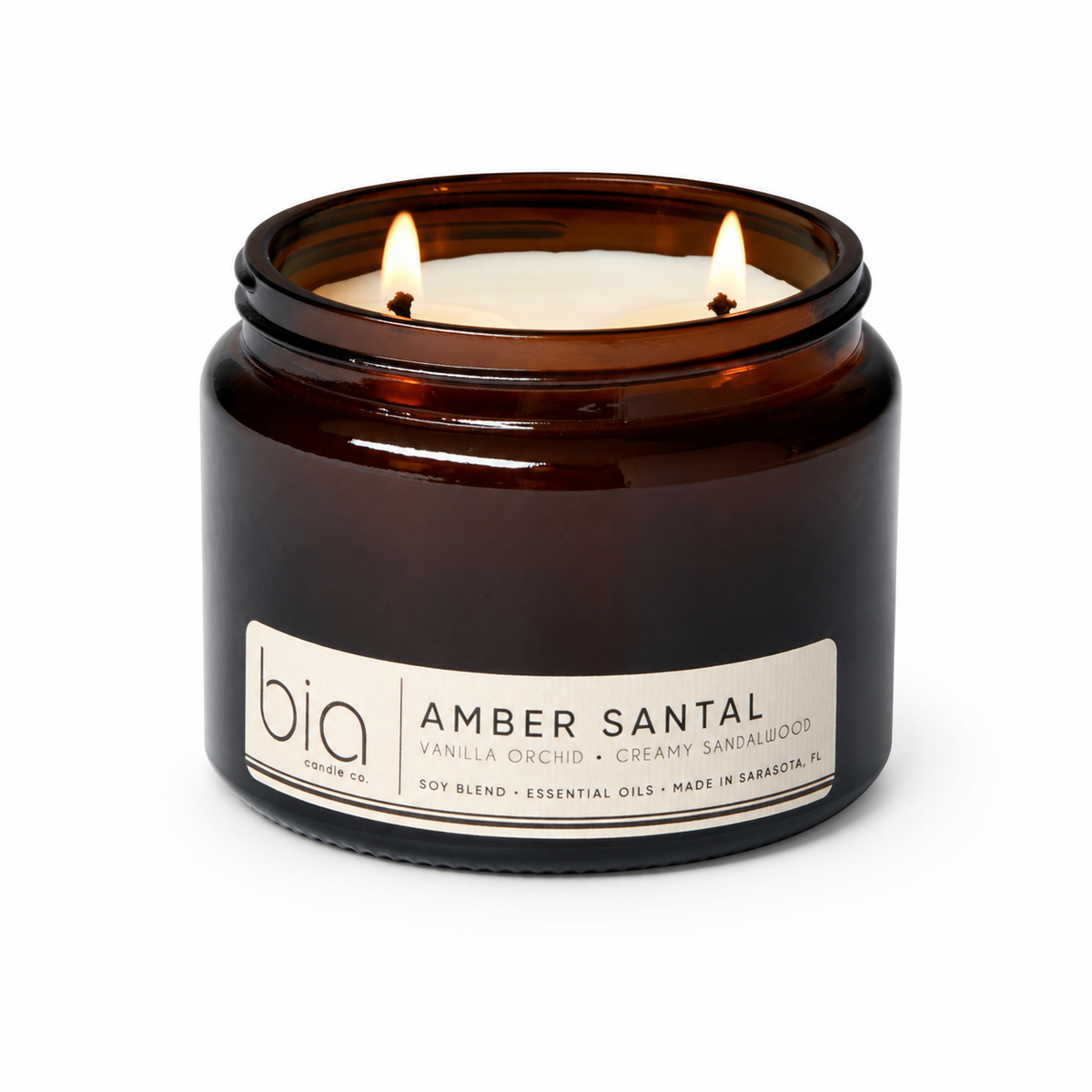 Amber glass soy candle jar with two flames and printed label
