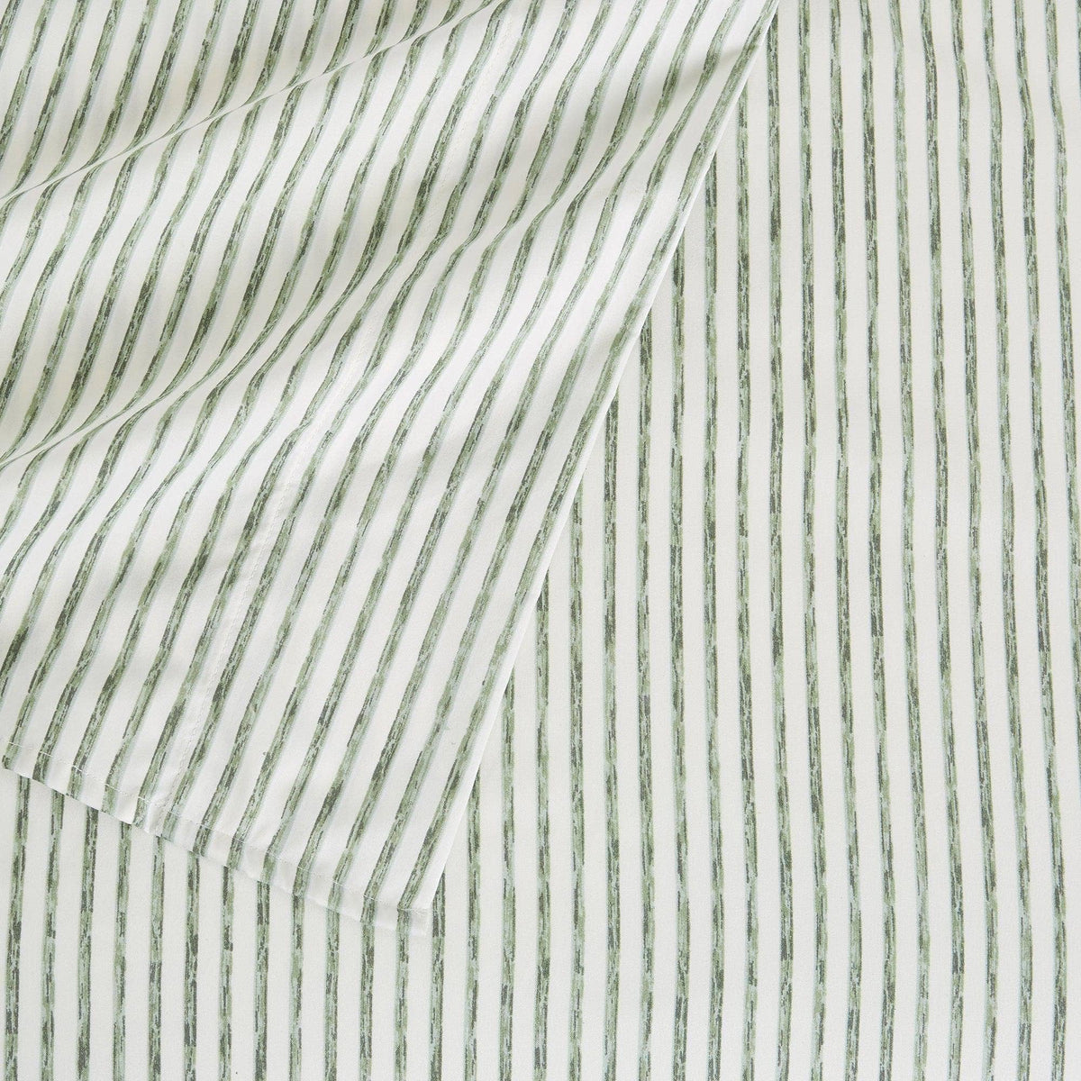 Microfiber sheet fabric close-up, white with green vertical stripe pattern