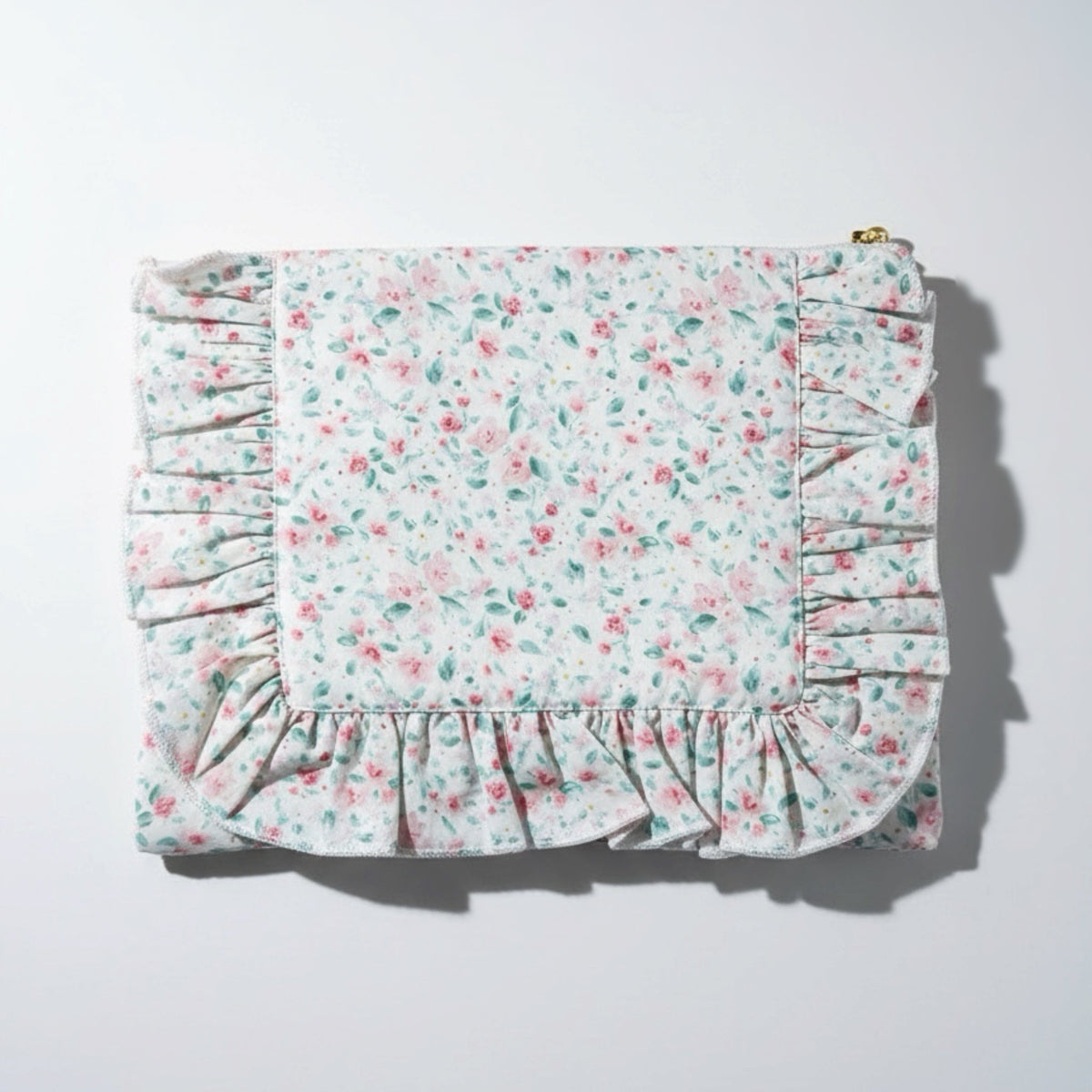 Pastel floral zip pouch with ruffled bottom trim and gathered side panels