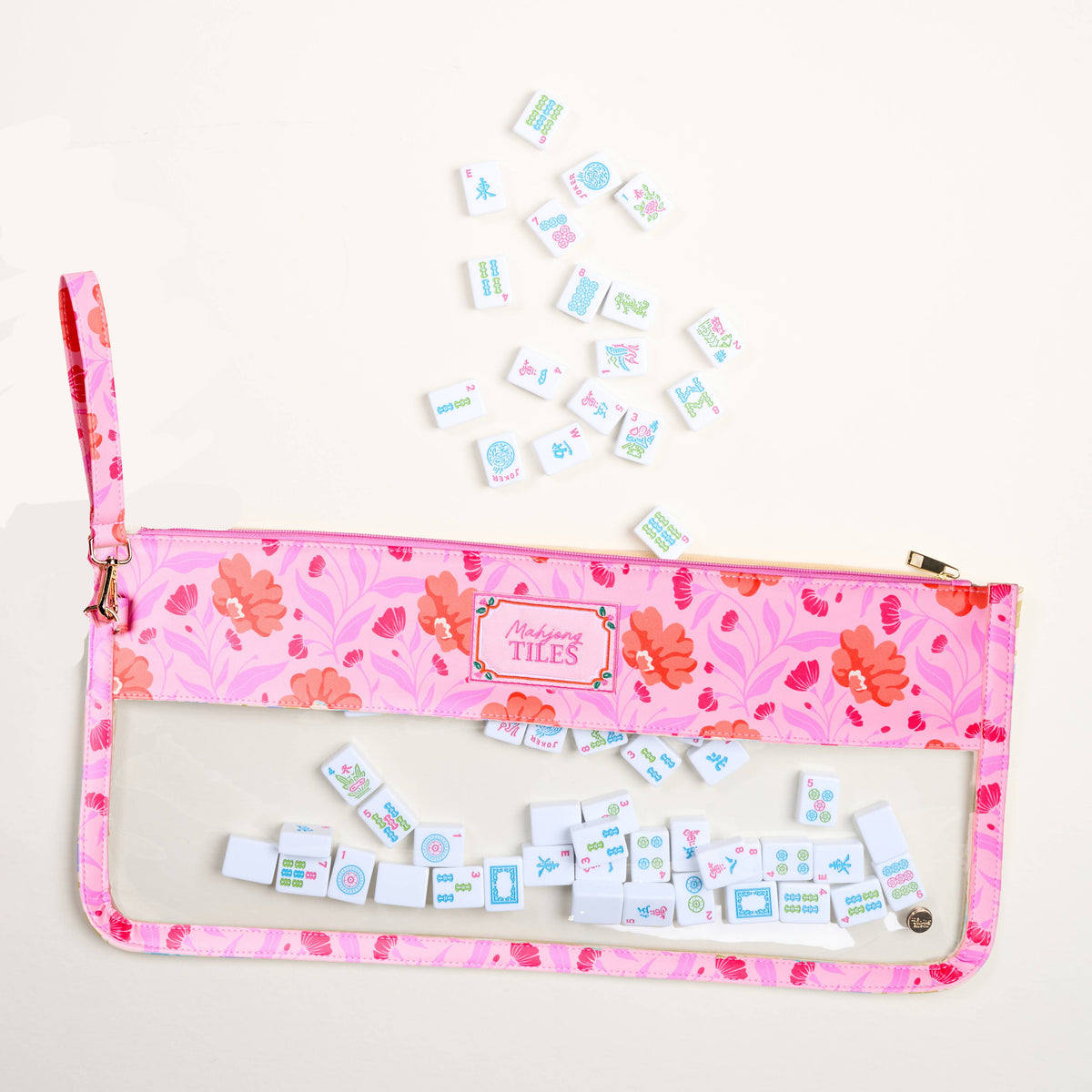 Hot pink floral Mahjong tile pouch with clear front window and zipper, plus tiles inside