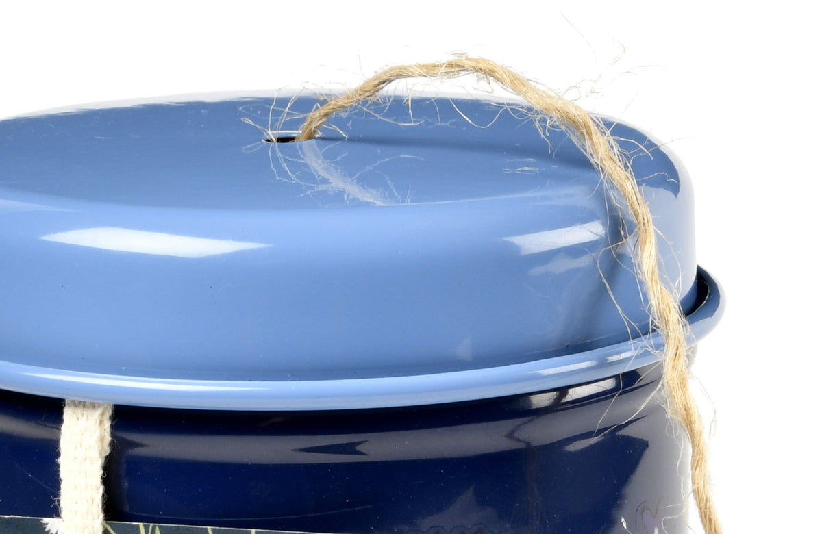 Blue metal twine tin lid close-up with gold string tied around the top