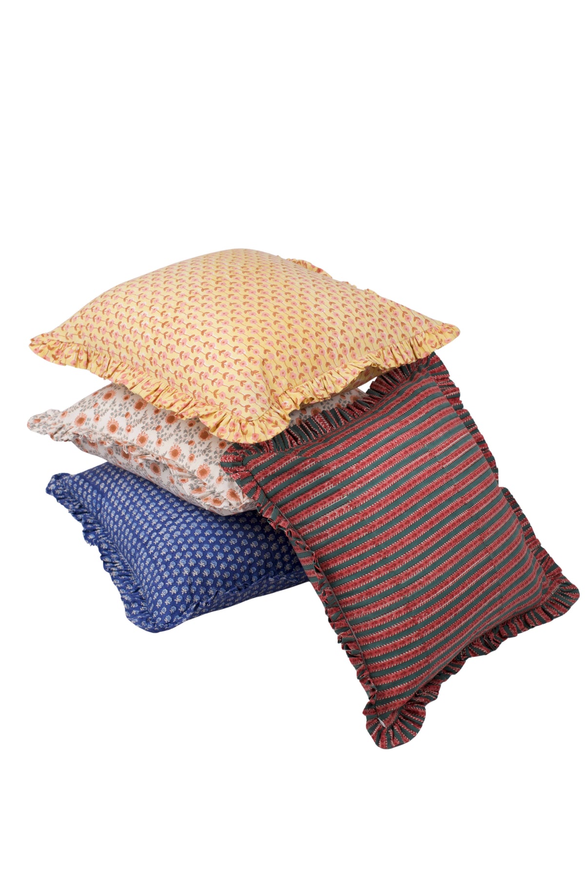 Stack of patterned pillow covers: yellow floral, white-orange ditsy, blue, and striped