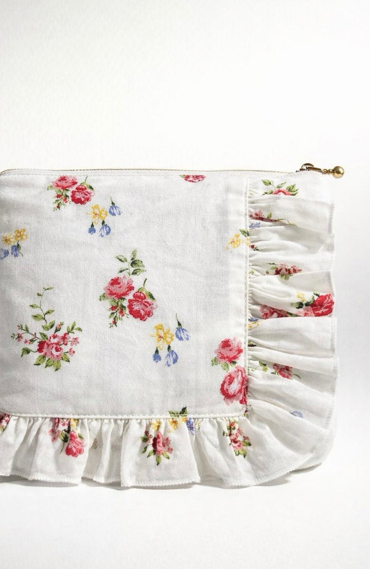 White floral ruffle zipper pouch close-up of side zipper and gathered ruffle trim