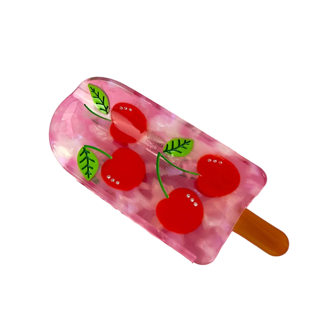 Cherry popsicle hair claw with translucent pink base, red cherry print, and tan prongs