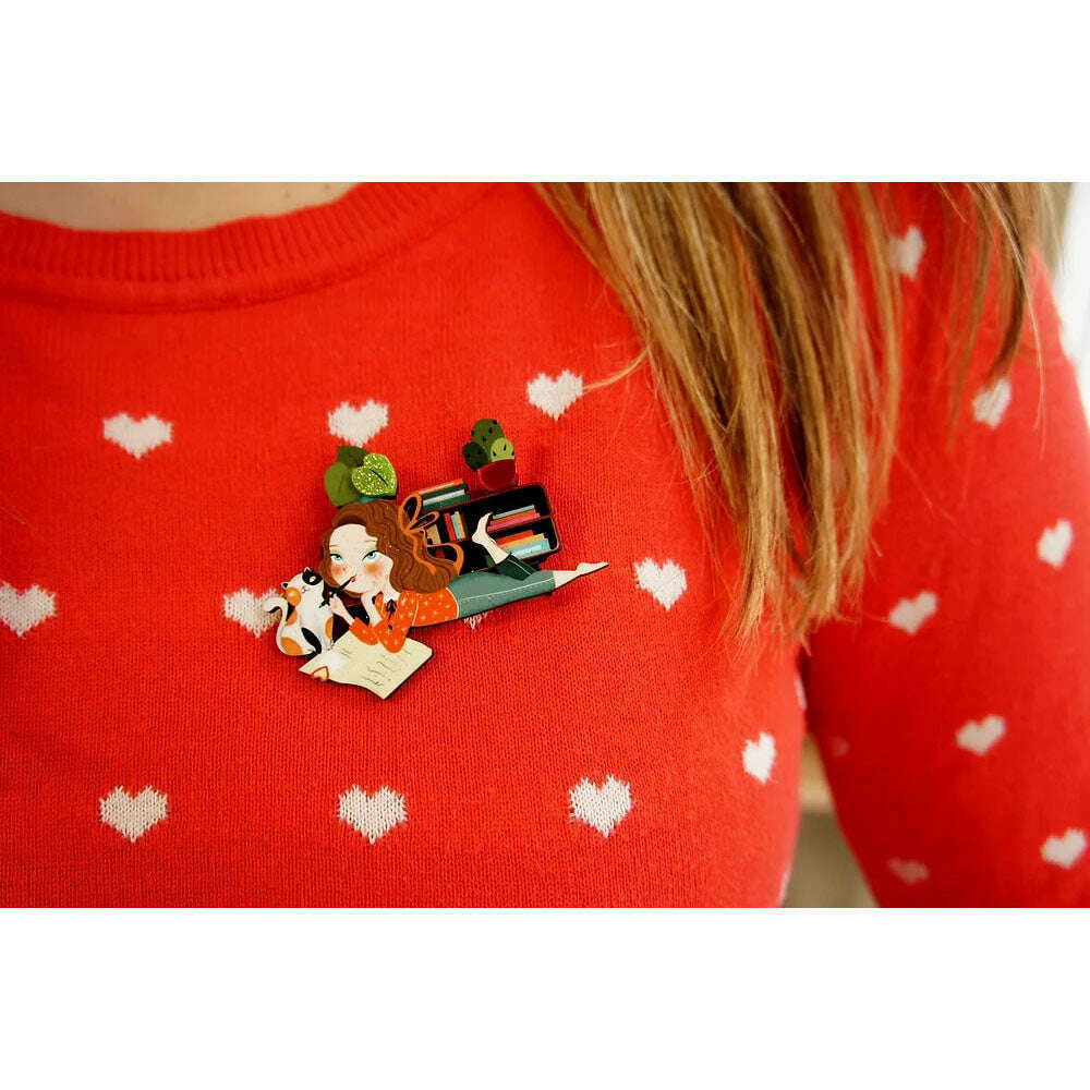 Laliblue diary enamel brooch on red sweater with hearts; illustrated girl and cat
