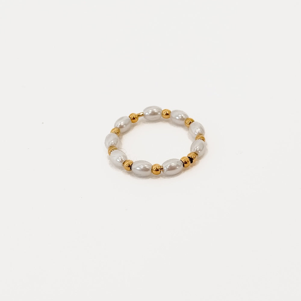 Pearl bead bracelet with gold spacer accents, shown on white