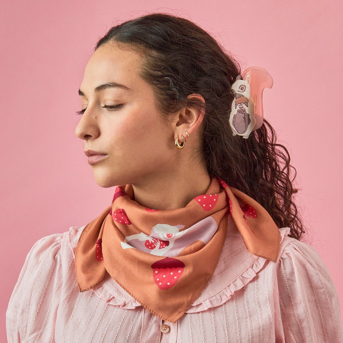 Tan cotton-silk bandana tied around the neck, showing strawberry print and rabbit.