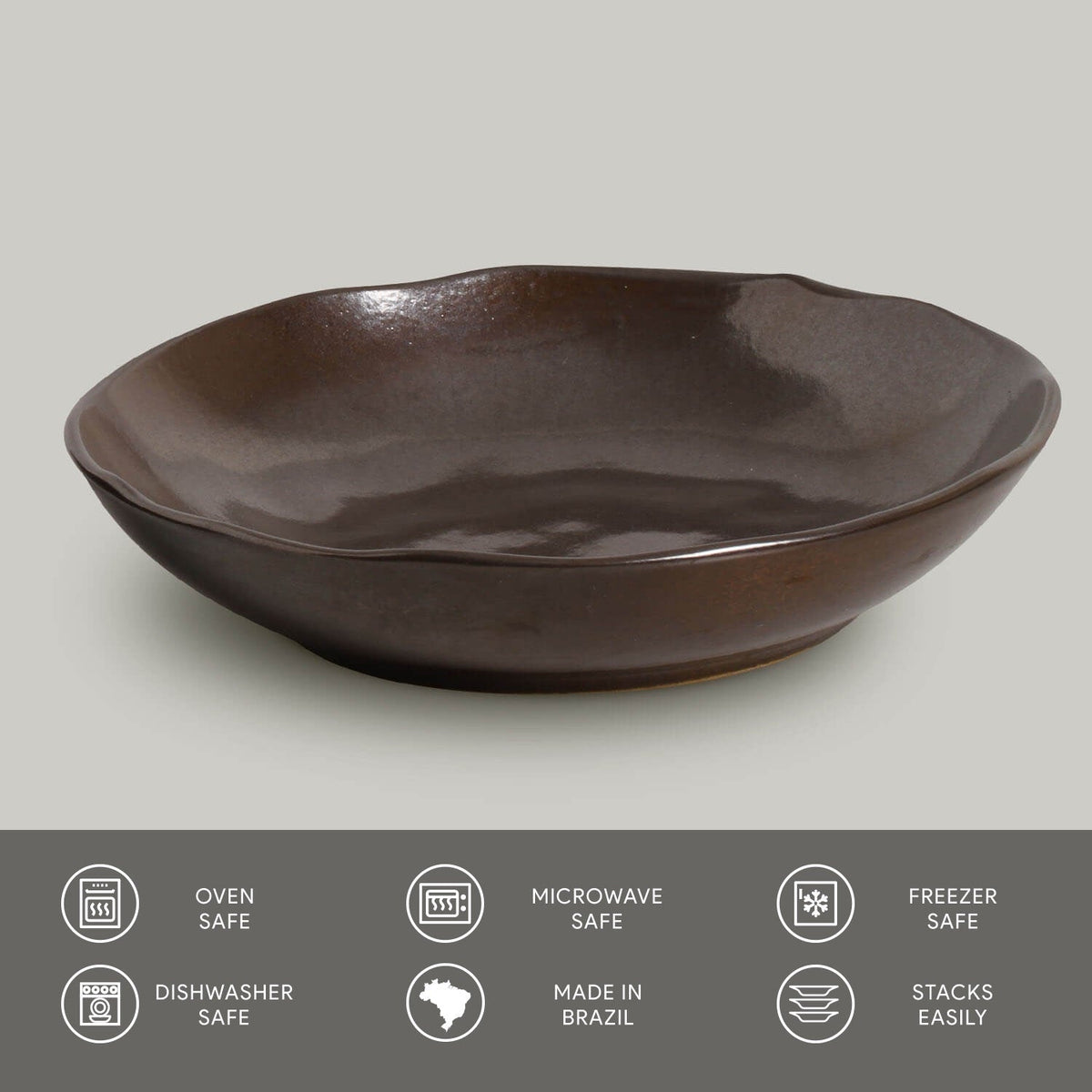 Dark brown ceramic pasta plate with glossy reactive glaze and slightly raised rim.