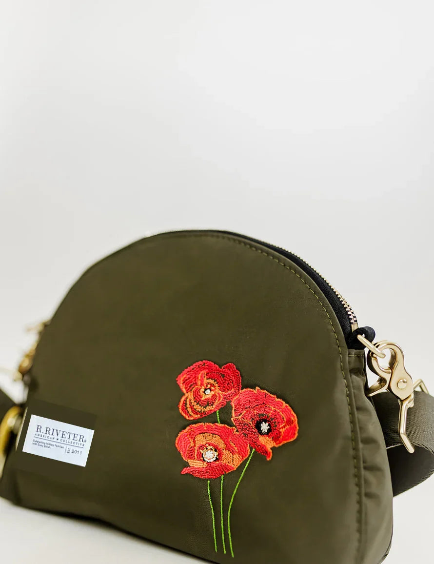 Olive dome bag close-up with red poppy floral embroidery and gold zipper pull