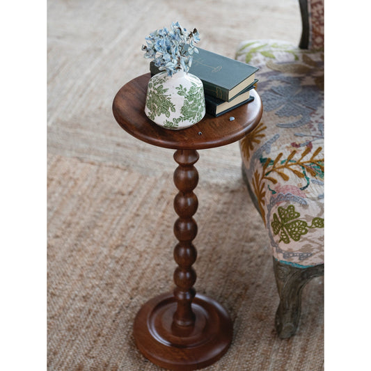 Turned mango wood martini table with round top and slender pedestal base