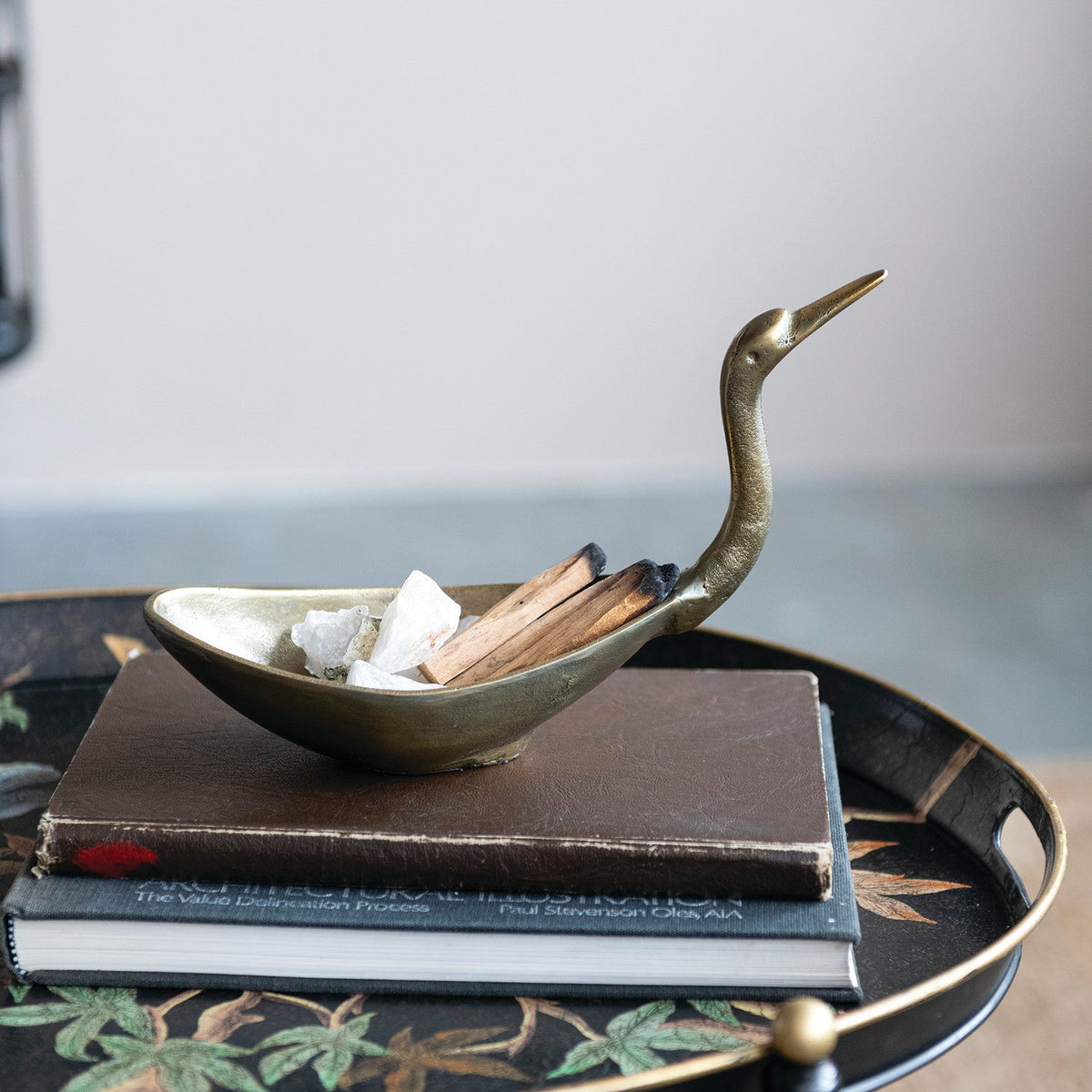 Bronze bird-shaped bowl filled with decorative ice and wood pieces