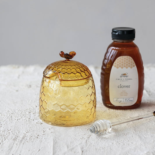 Glass honey jar with bee finial and matching honey dipper, amber-gold