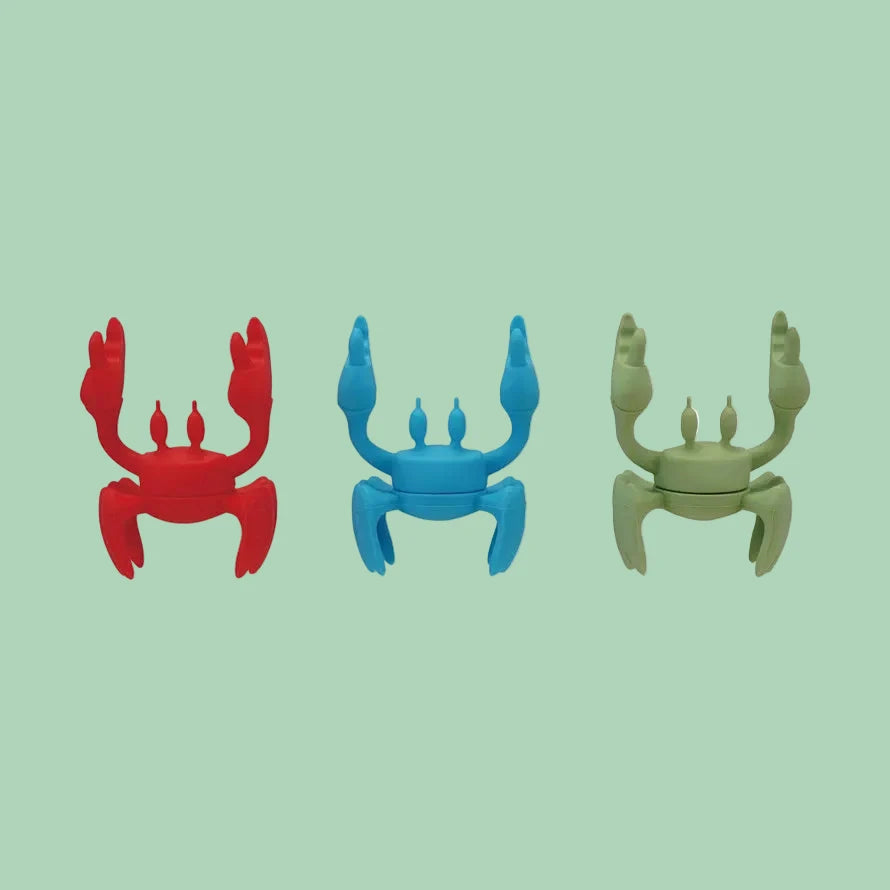 Silicone crab-shaped lid/spoon holder set in red, blue, and green