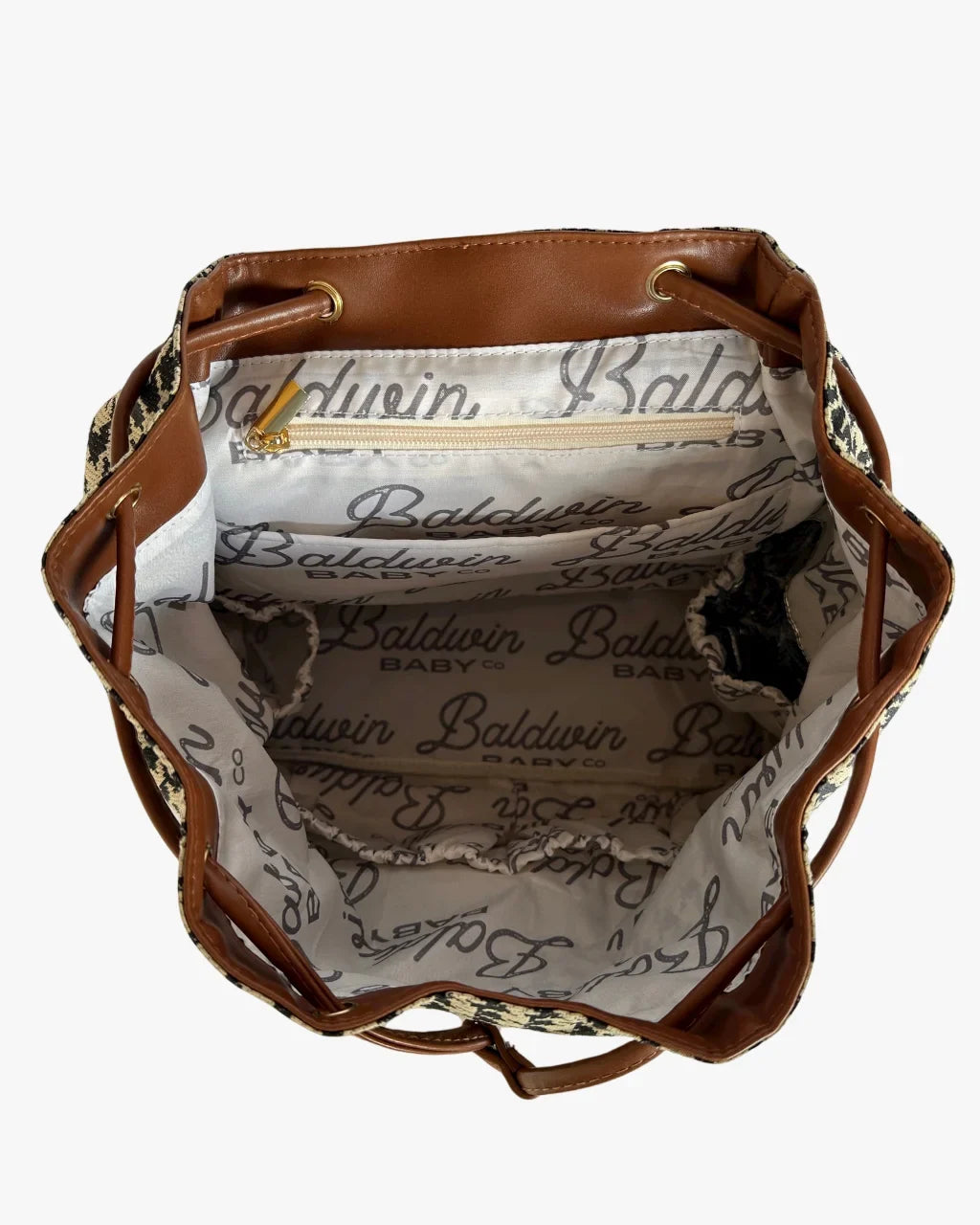 Open diaper bag showing branded lining, interior pocket, and gold-tone zipper