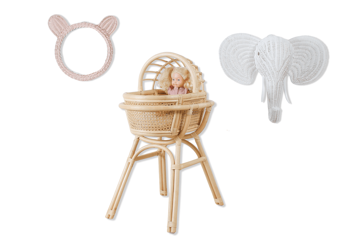 Pink rattan teddy bear mirror displayed beside a woven doll chair