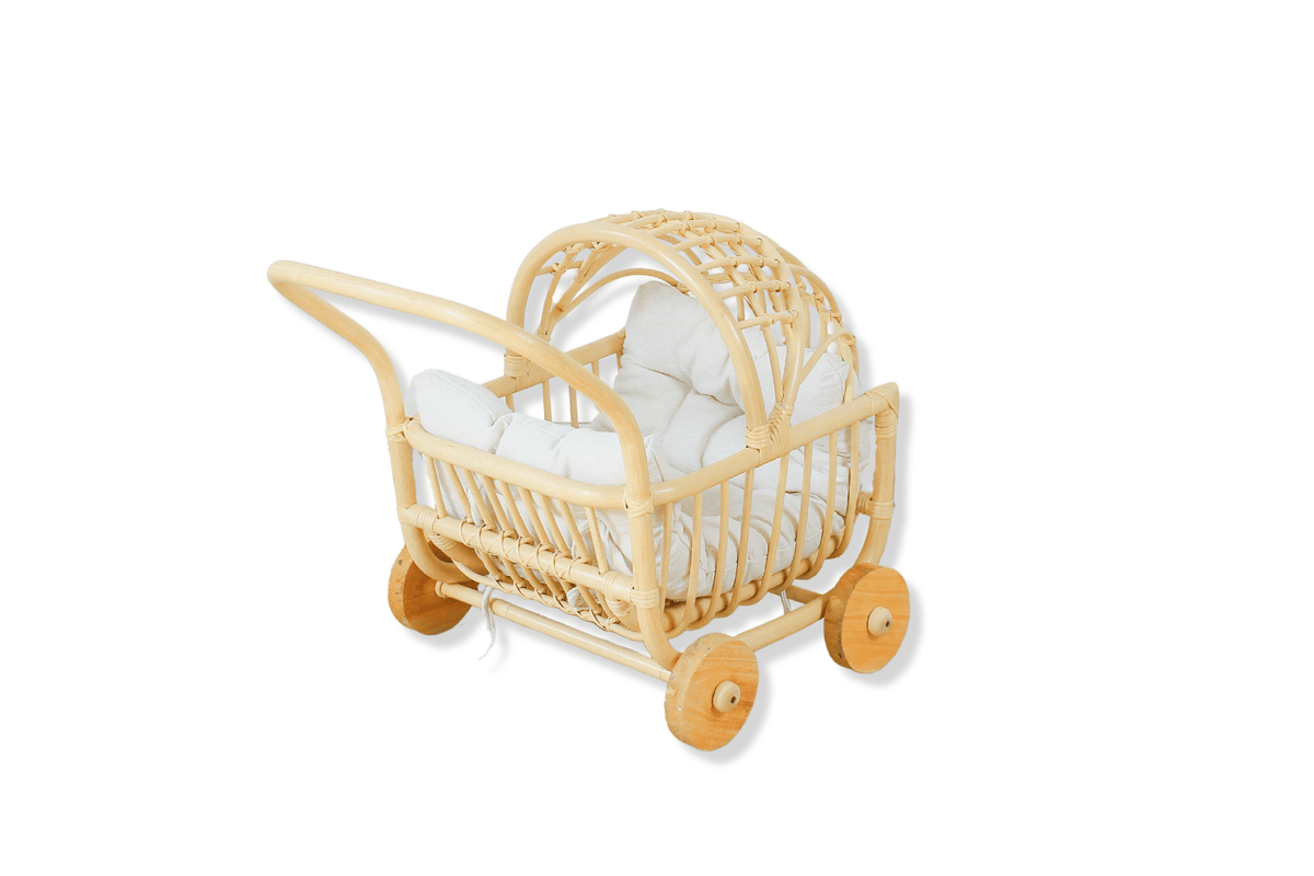 Natural woven rattan doll stroller with canopy, white cushion, and four wooden wheels