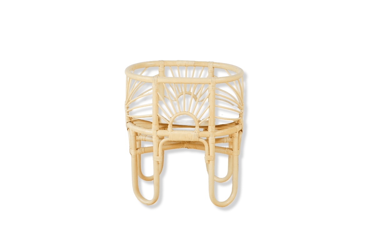 Toy doll crib with a woven frame, sunburst details and curved legs