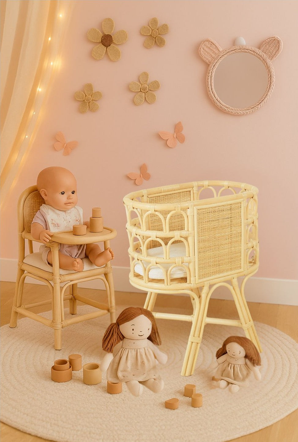 Natural rattan doll crib with woven side panels and elevated legs, shown empty