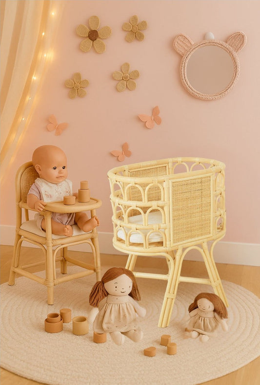 Natural rattan doll crib with woven side panels and elevated legs, shown empty