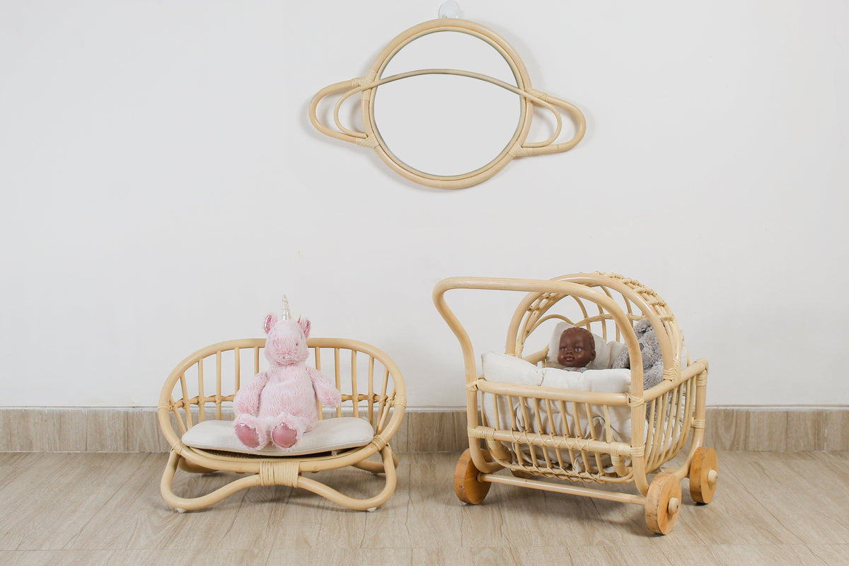 Rattan doll stroller with canopy and bedding, shown beside a matching doll seat