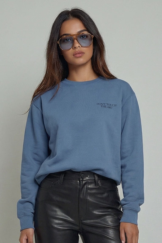 Blue crewneck sweatshirt with "DON'T TOUCH THE ART" chest text