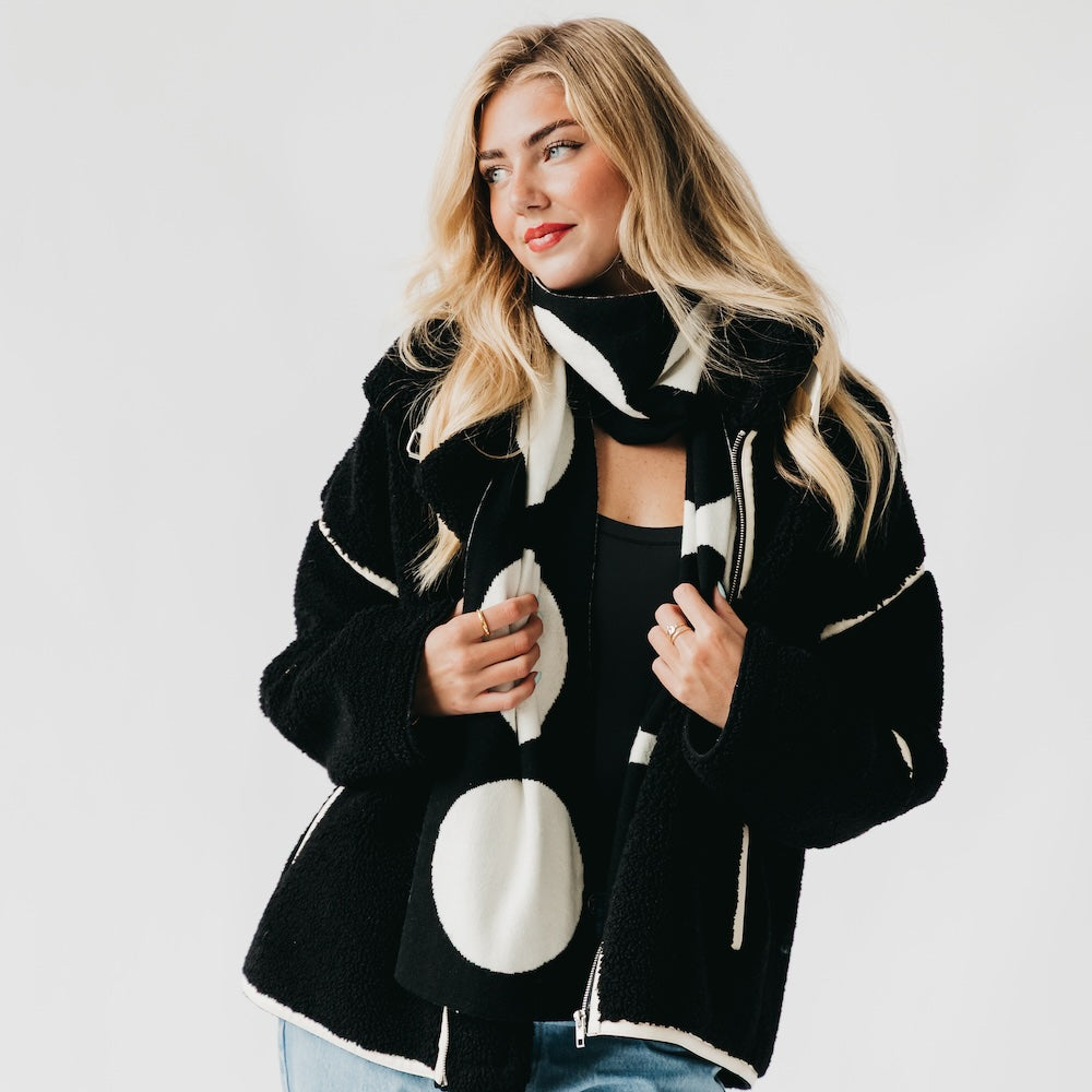 Black scarf with large white dot pattern, long drape with soft ends
