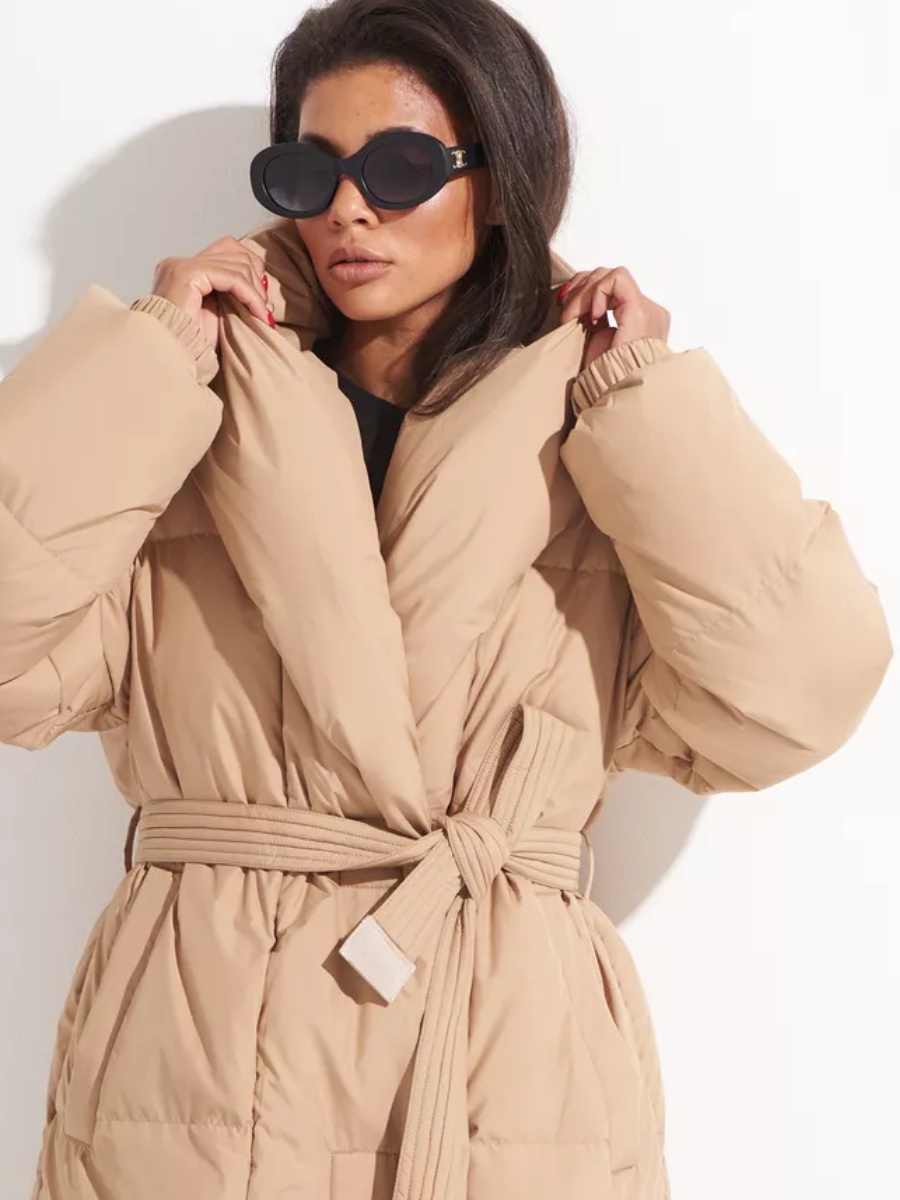 Close-up of the coat's padded collar, gathered cuffs, and tied belt