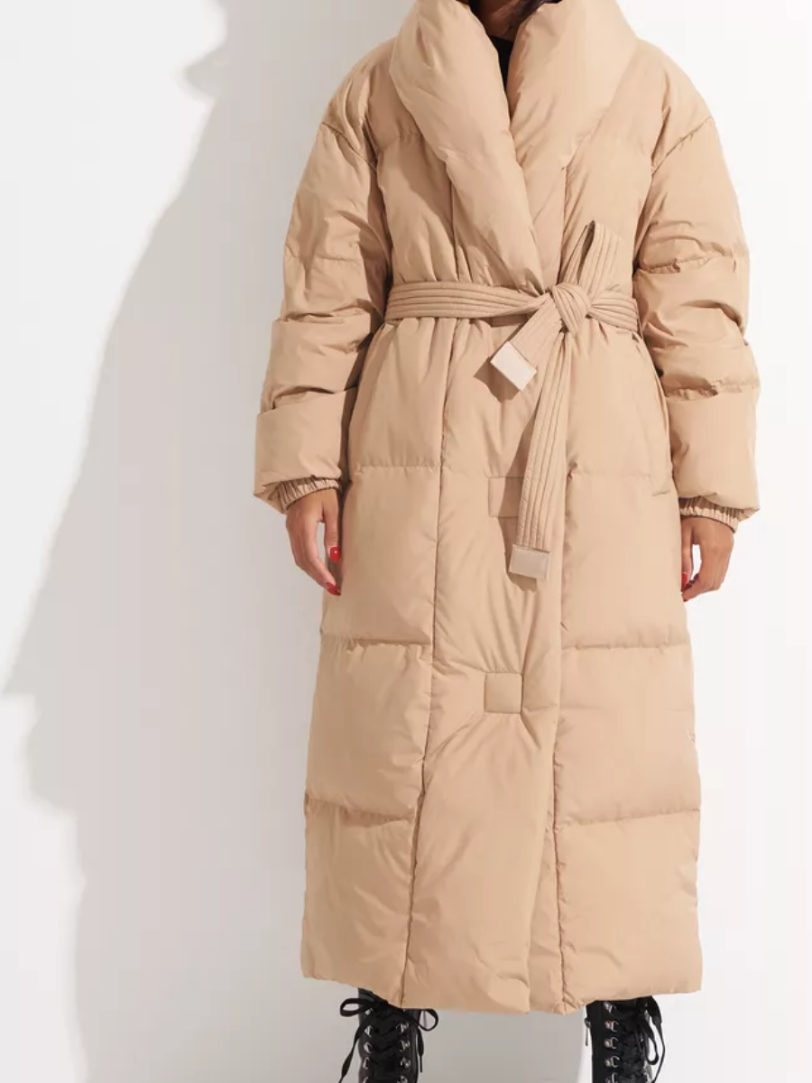 Full-length caramel down coat with tie belt and wide horizontal quilting